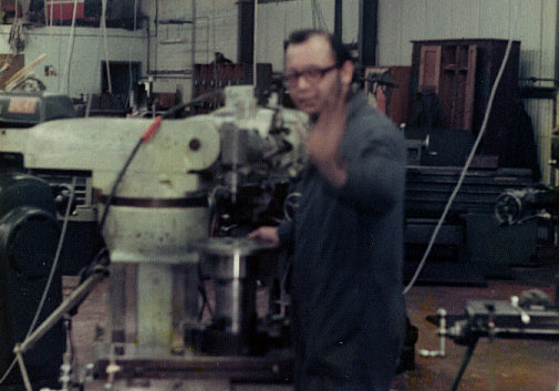 Historic photograph of a machinist working in the family precision engineering workshop, circa 1984