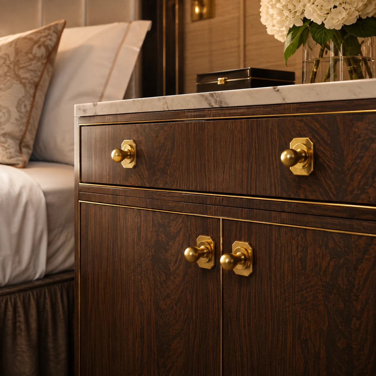 Illustrative hotel bedside casegoods with Capramont Lexham cabinet knobs and baseplates