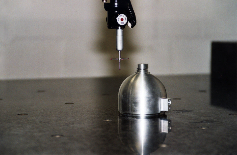 Coordinate measuring machine inspecting a precision machined component